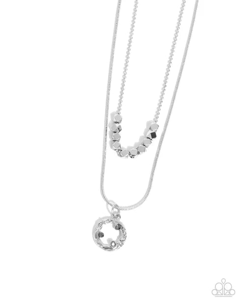 Necklace with circular pendant and beaded chain on white background