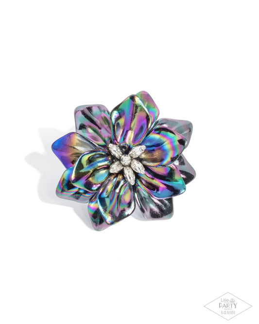 Multicolored flower-shaped hair clip on a white background