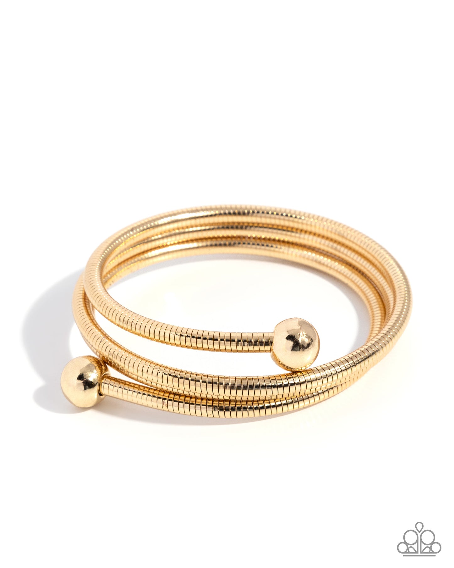 Set of gold bangles with spherical ends on a white background