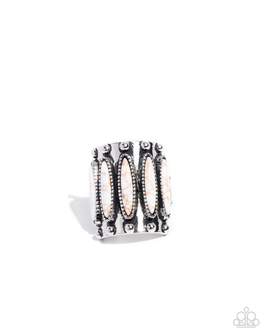 Silver ring with intricate design on a white background