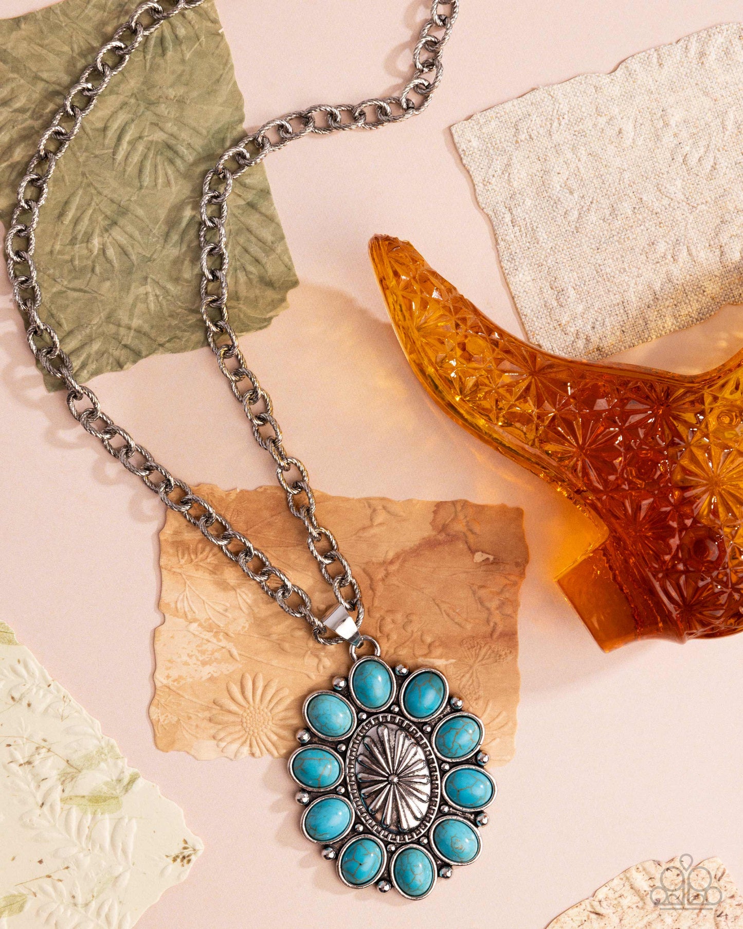 Necklace with a turquoise pendant on a textured surface
