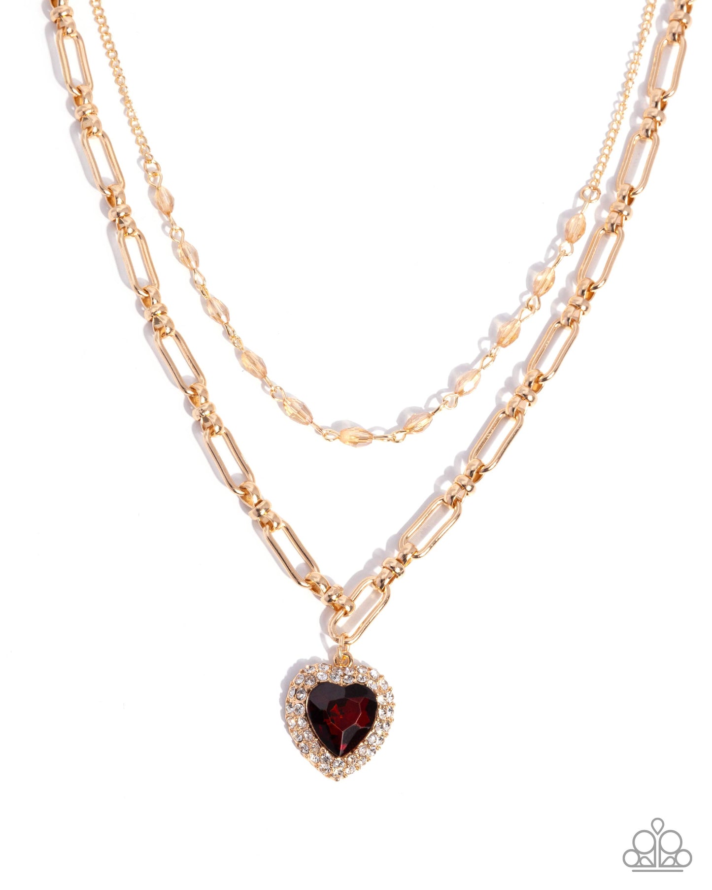 Layered gold necklaces with a heart-shaped garnet pendant on a white background