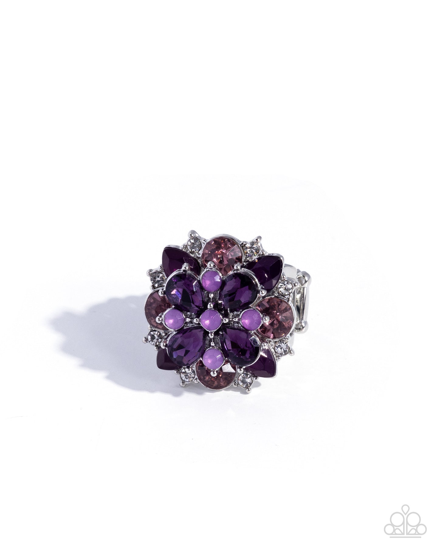 Purple floral ring with gemstones on a white background
