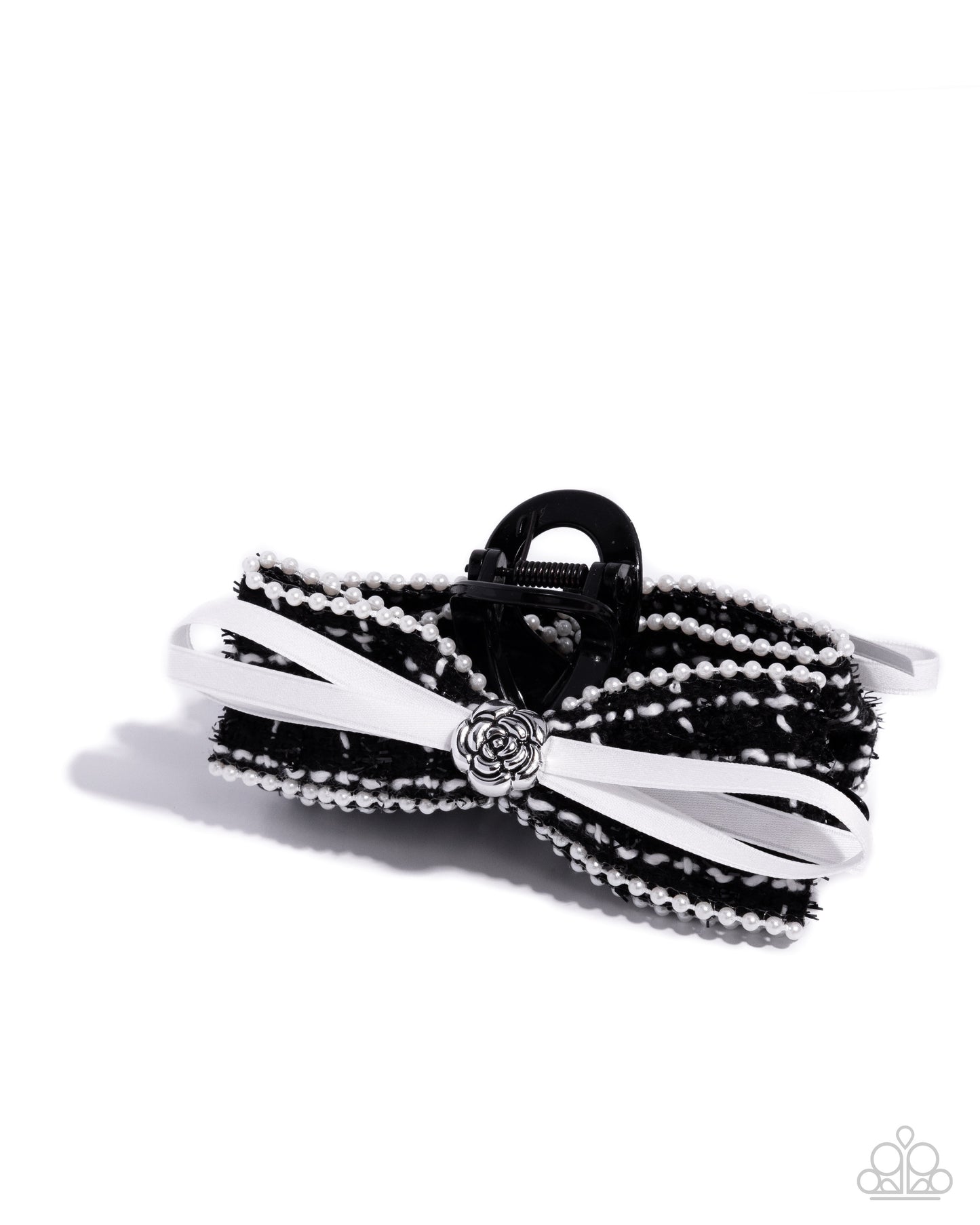 Black and white braided hair tie with decorative clasp on a white background