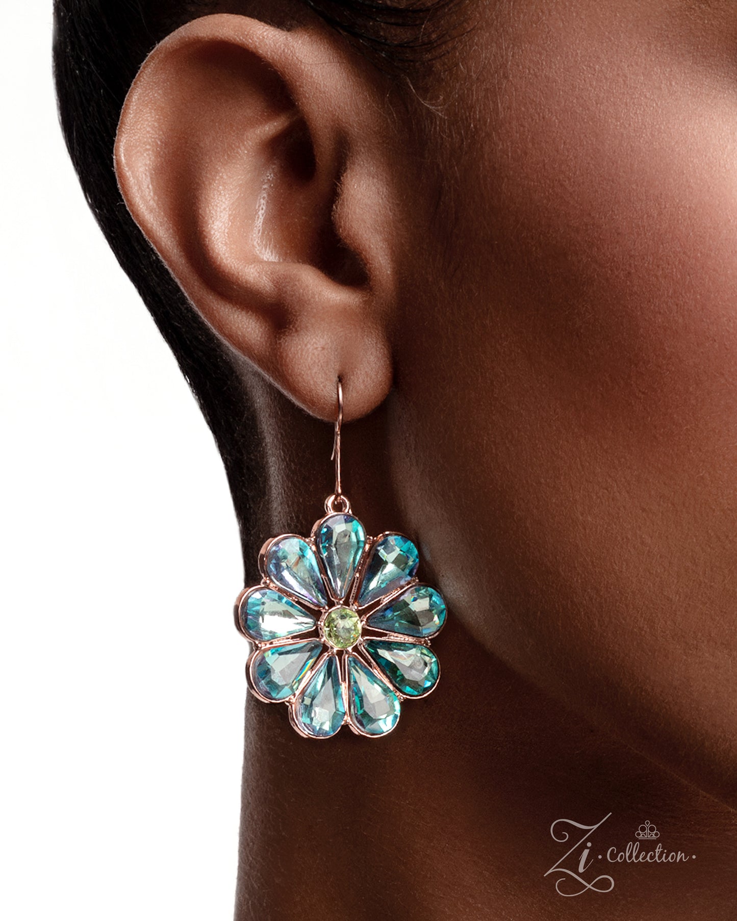 Close-up of an ear wearing a floral earring with turquoise stones, brand 'ZI Collection' visible.