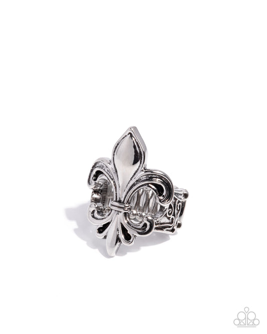 Silver fleur-de-lis ring on a white background