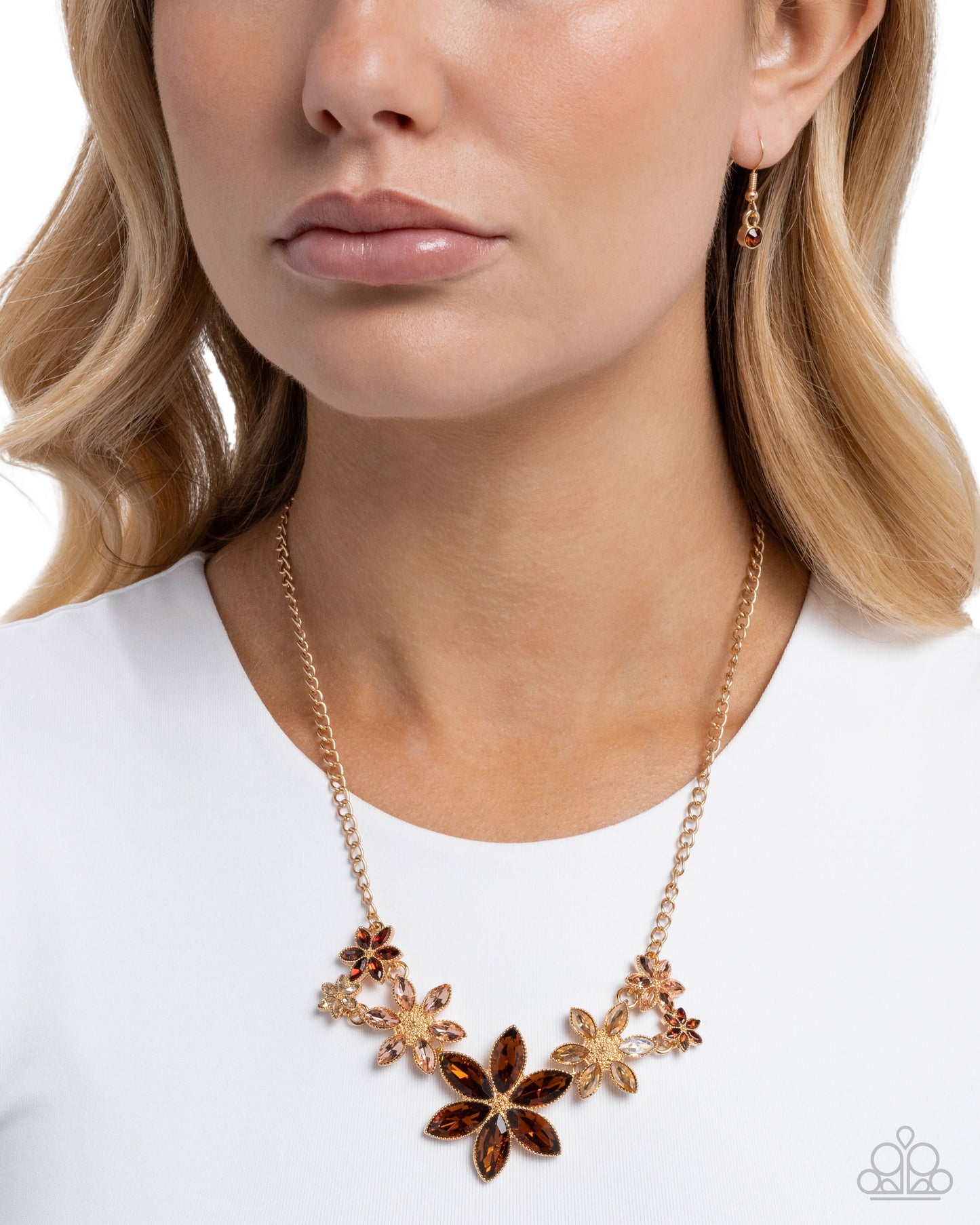 Necklace with floral design worn by a model on a white background