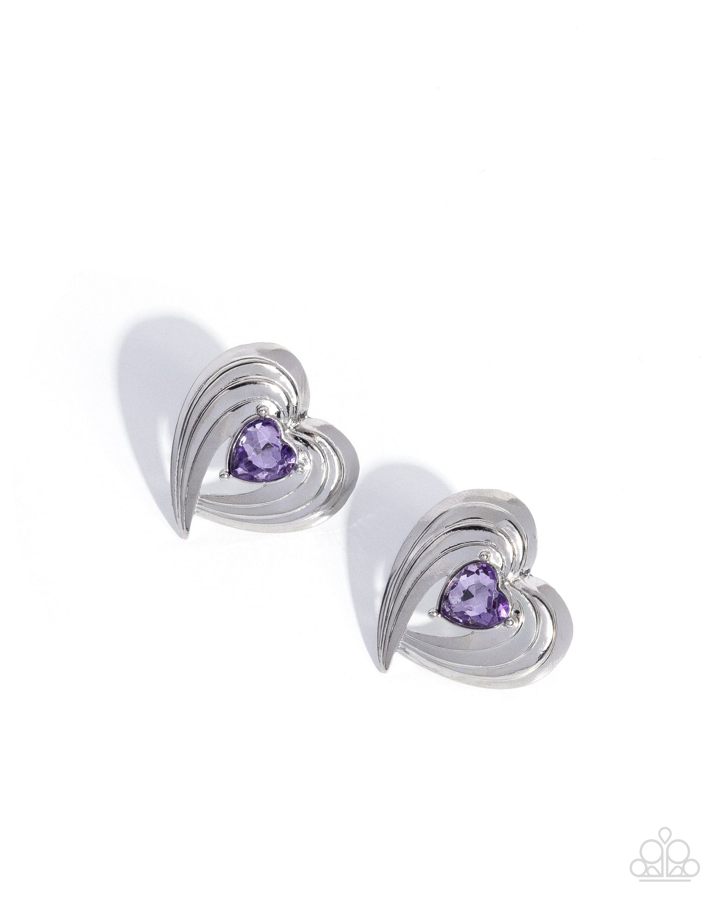 Pair of silver heart-shaped earrings with purple gemstones on a white background