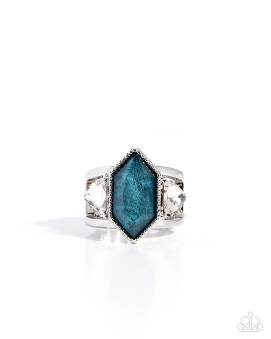Silver ring with a blue gemstone on a white background