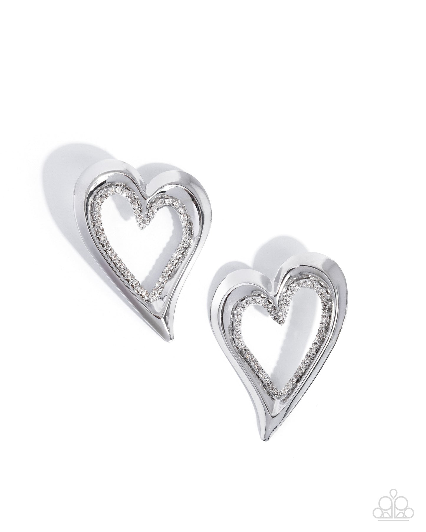 Heart-shaped silver earrings with clear gemstones on a white background