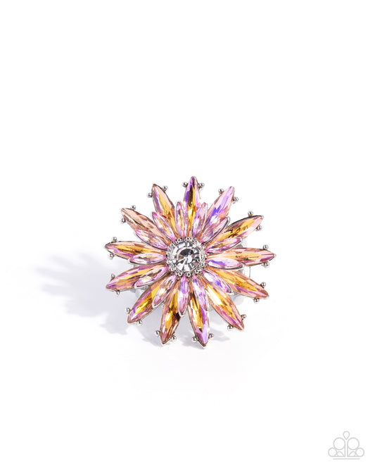Multicolored starburst brooch on a white background
