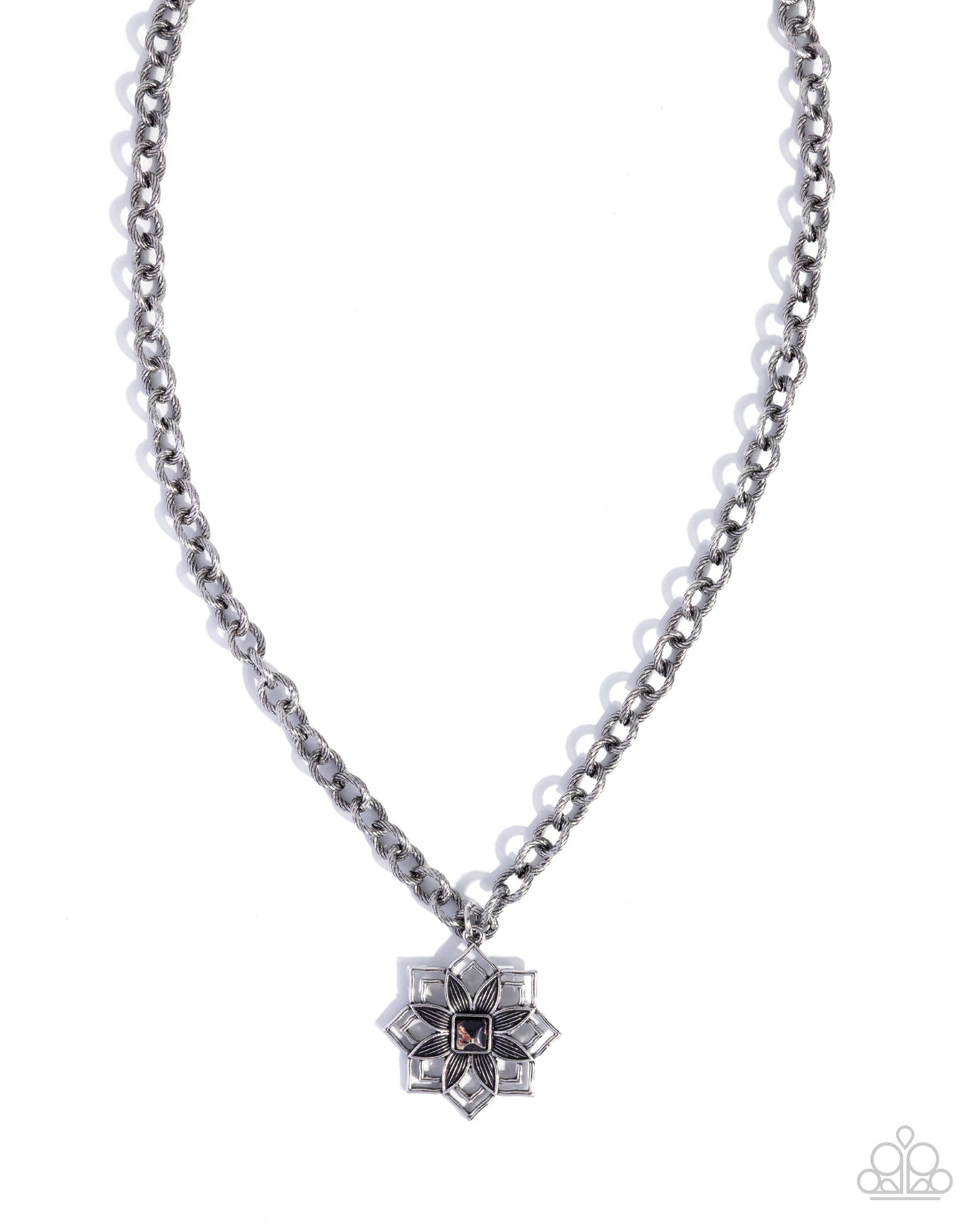 A silver-toned chain necklace with a geometric starburst pendant featuring clear rhinestones and a small dark center, shown on a plain white background. A Paparazzi logo watermark is visible in the bottom right corner.