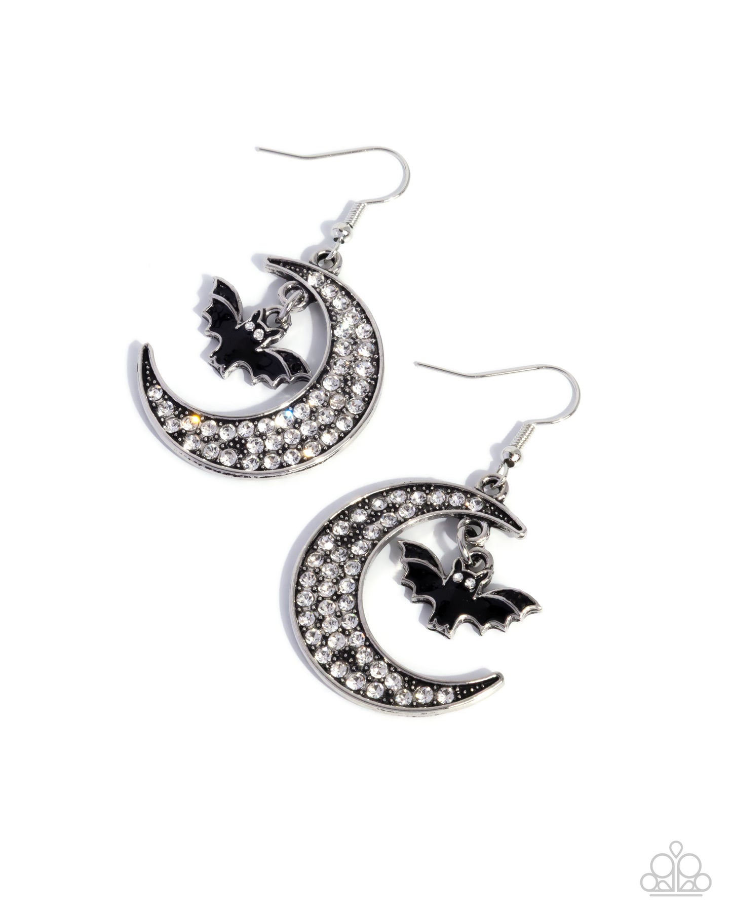 Pair of earrings with crescent moon and bat design on a white background