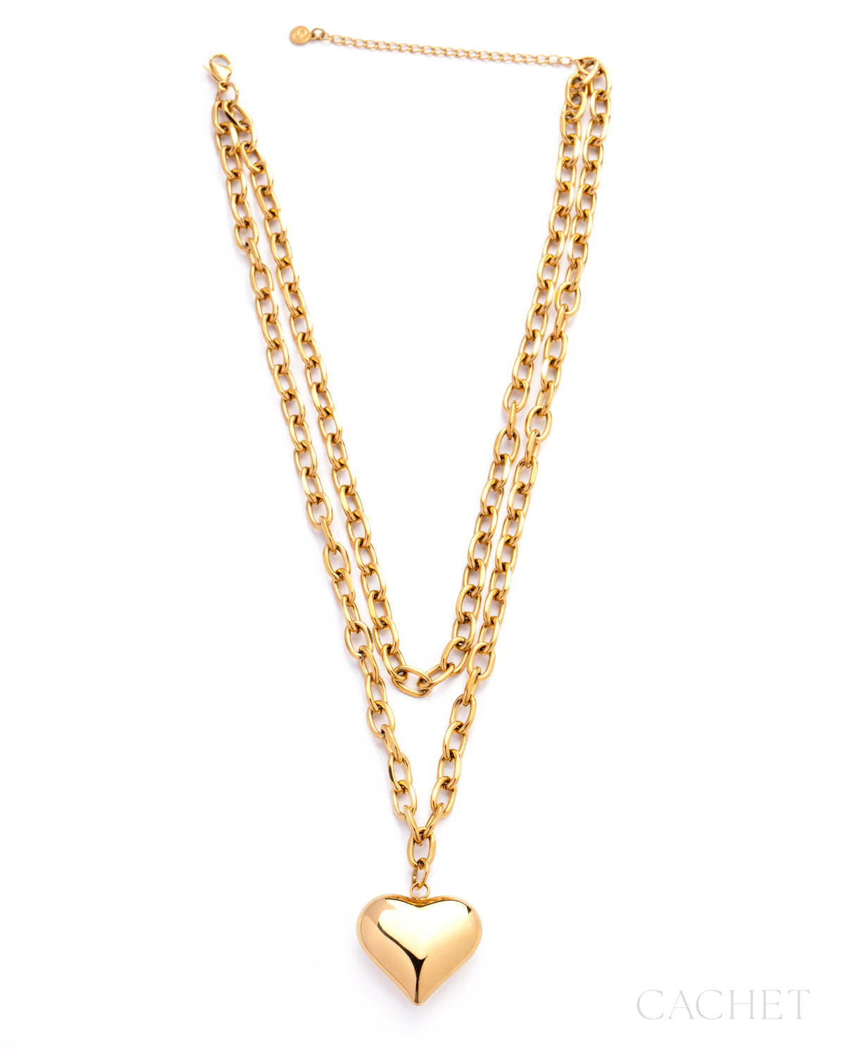 Gold chain necklace with a heart pendant on a white background