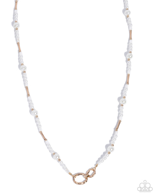 A delicate necklace featuring small white faux pearls and polished rose gold metal tube accents, with a matching rose gold infinity clasp, shown against a plain white background.