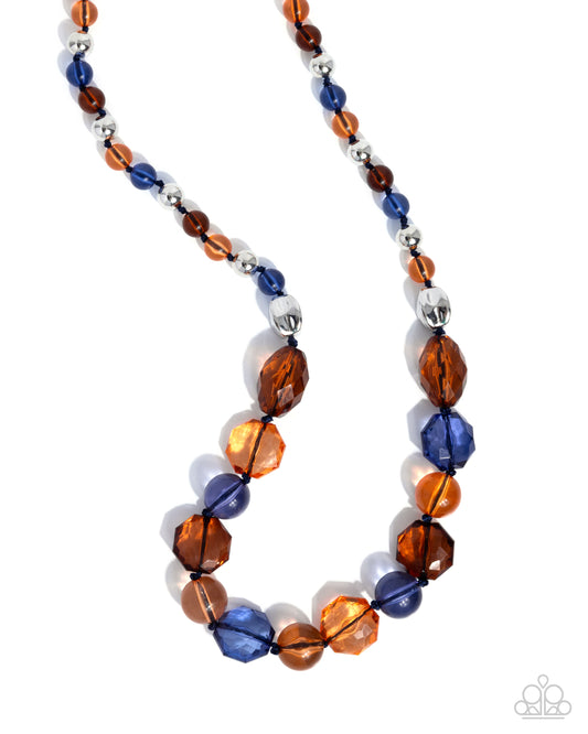 A beaded necklace featuring faceted amber-brown, deep blue, and metallic silver beads, displayed on a clean white background.