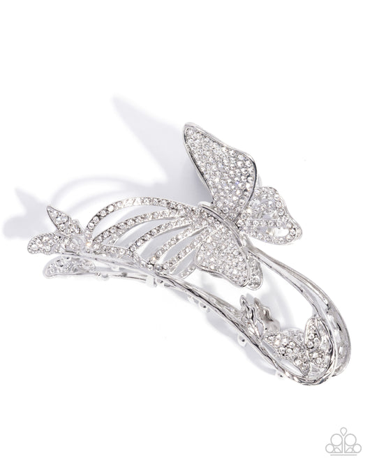 Silver butterfly brooch on a white background