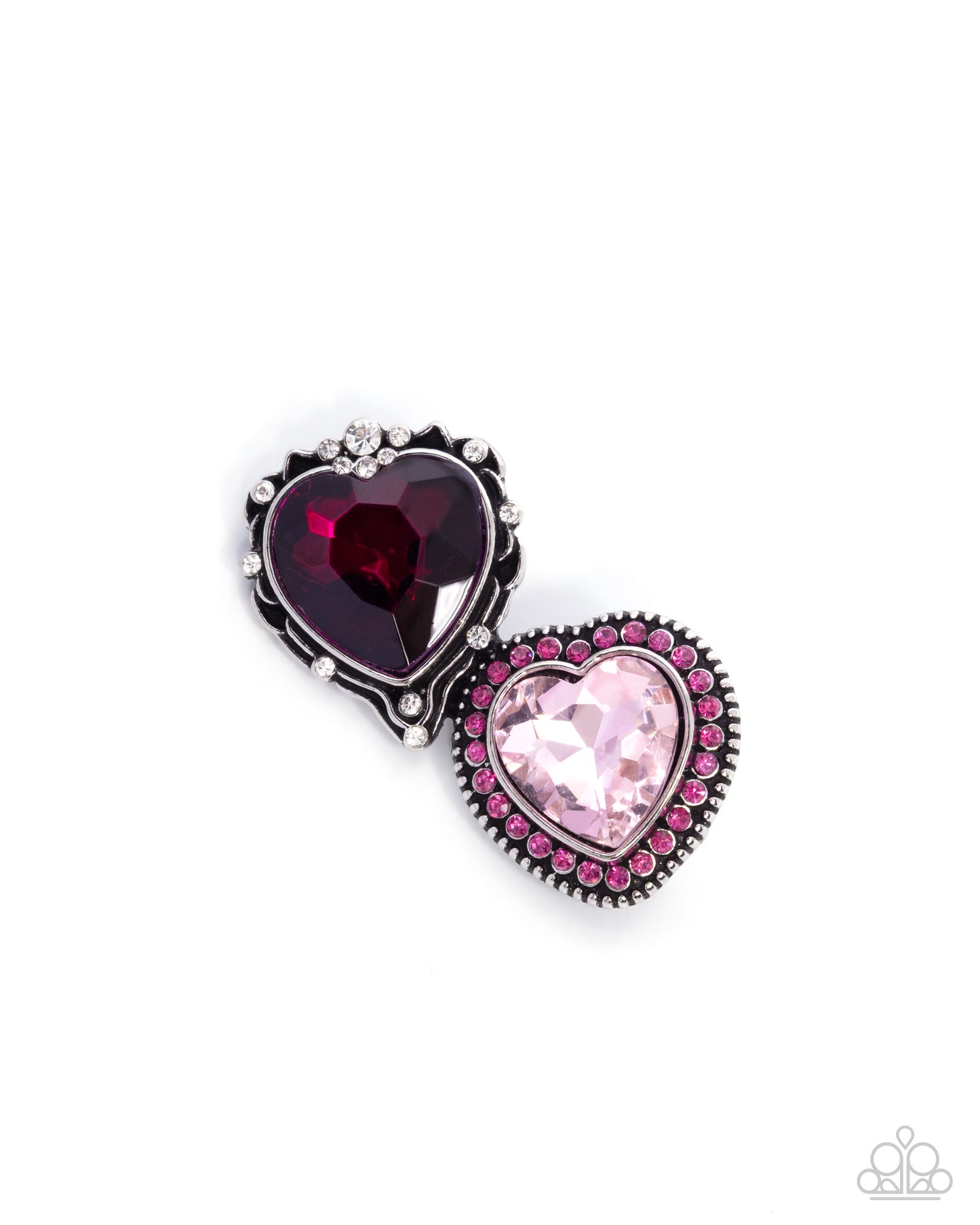 Heart-shaped jewelry piece with red and pink gemstones on a white background