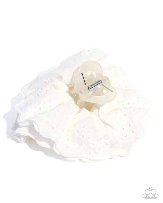 White garter with decorative bow on a white background
