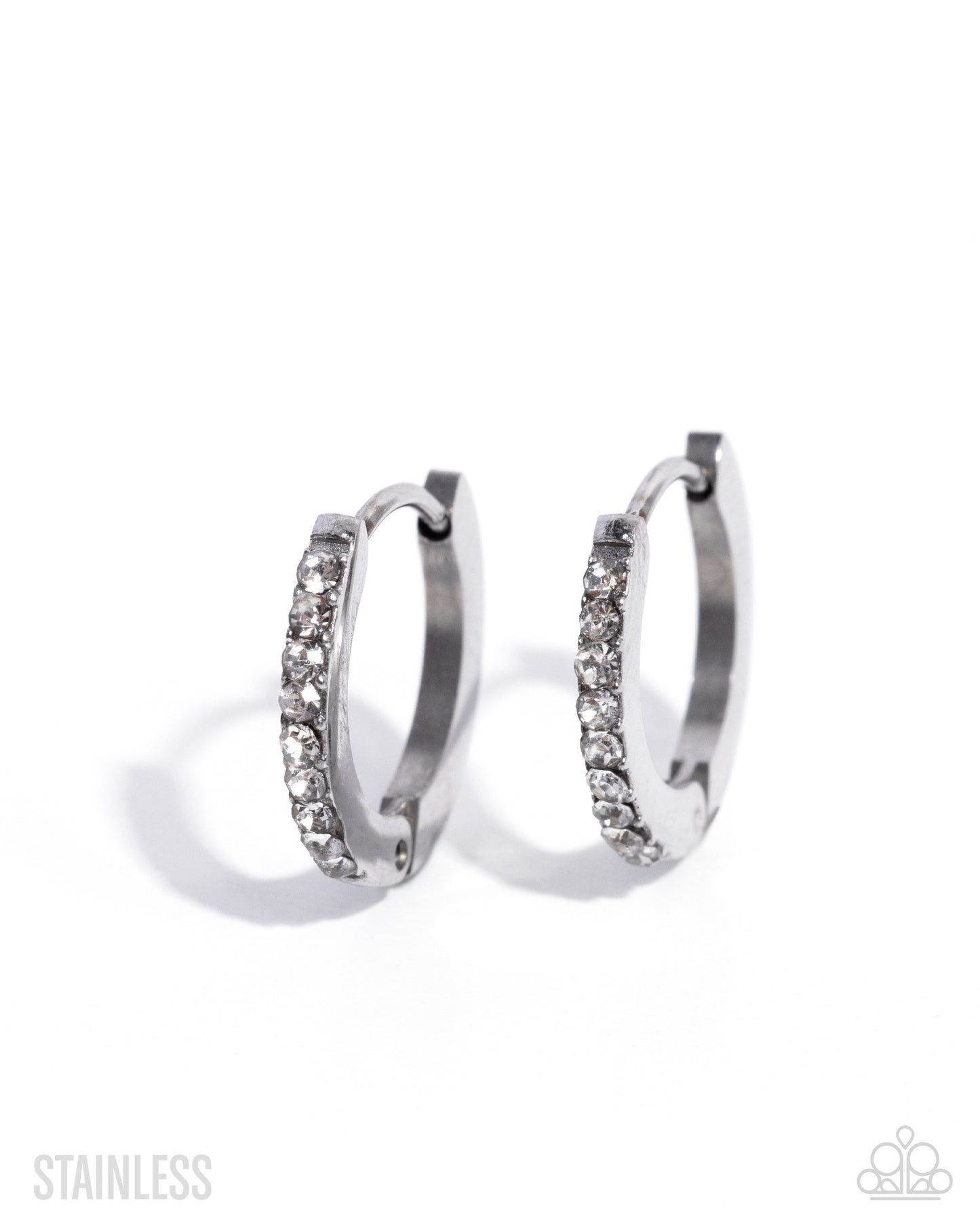 Pair of silver hoop earrings with clear gemstones on a white background
