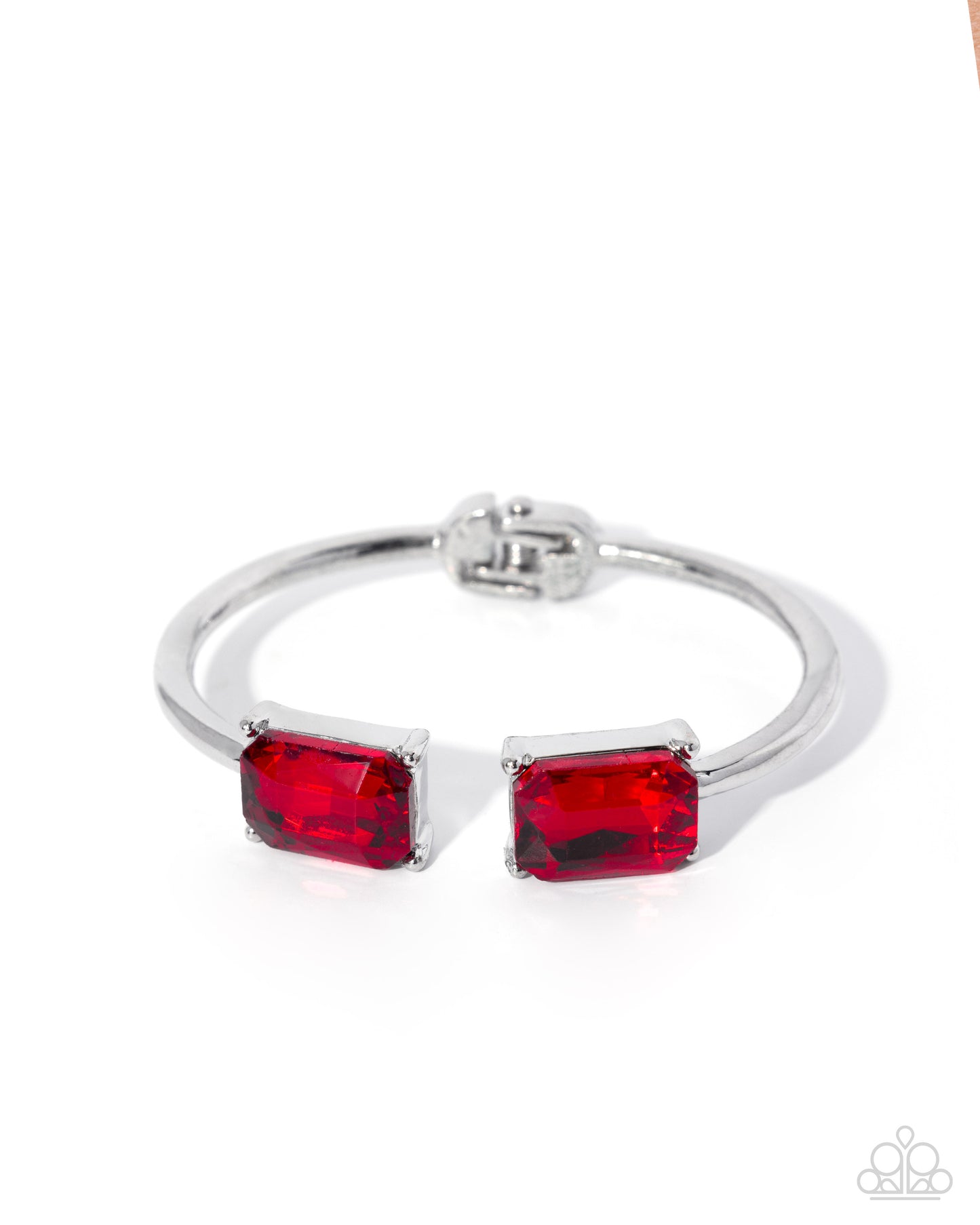 Silver bracelet with red gemstones on a white background