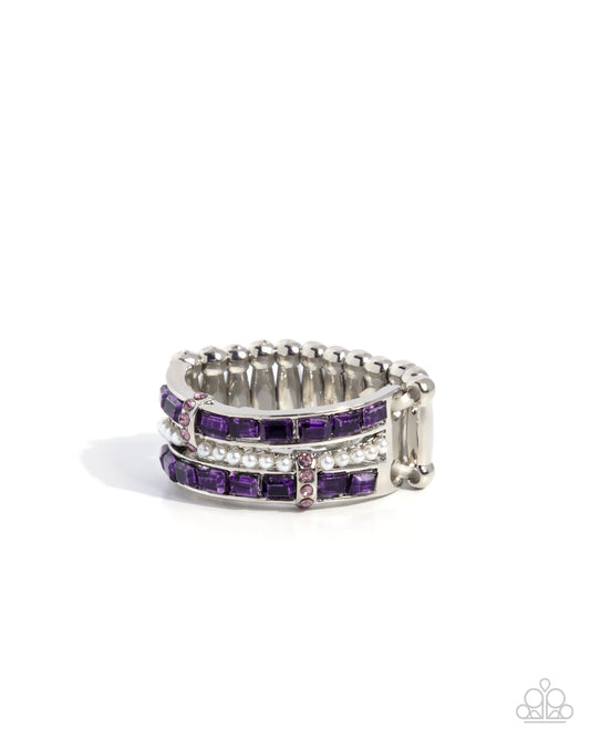 Silver ring with purple gemstones on a white background