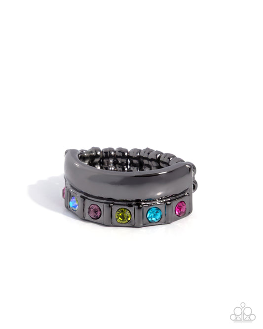 Black ring with colorful gemstones on a white background
