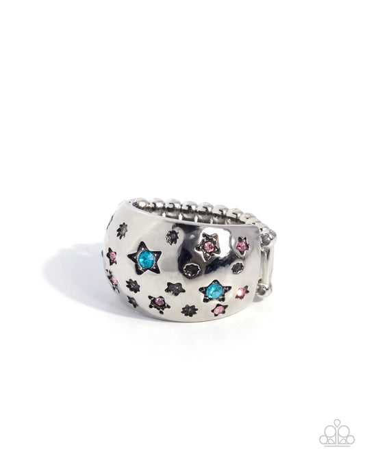 Silver ring with star-shaped gemstones on a white background