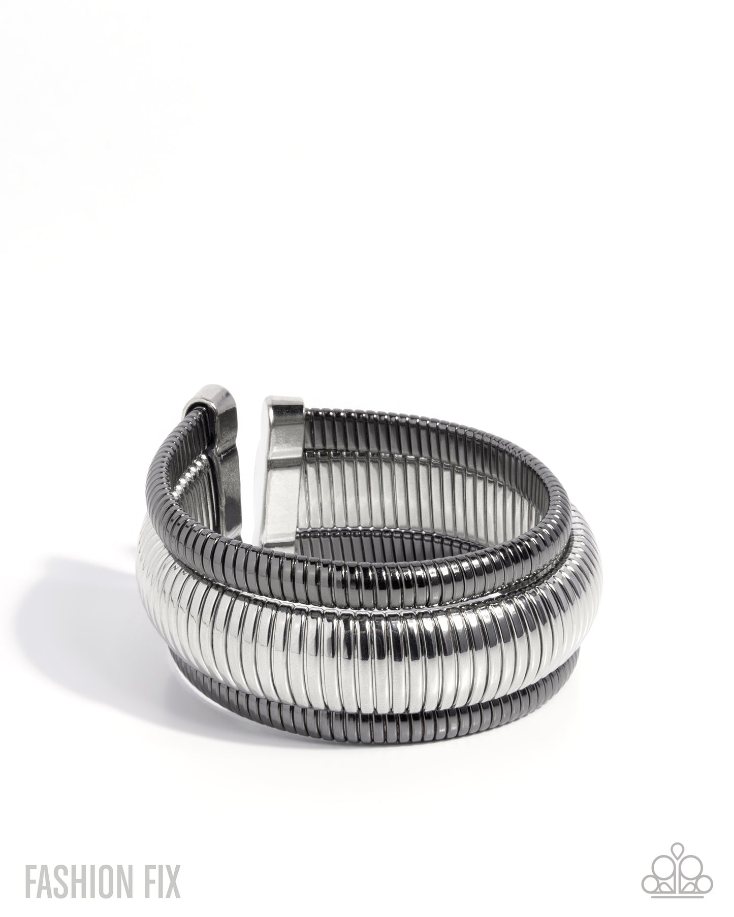 A silver-toned metal cuff bracelet with a textured, ribbed outer band and a smooth inner band, shown on a plain white background.