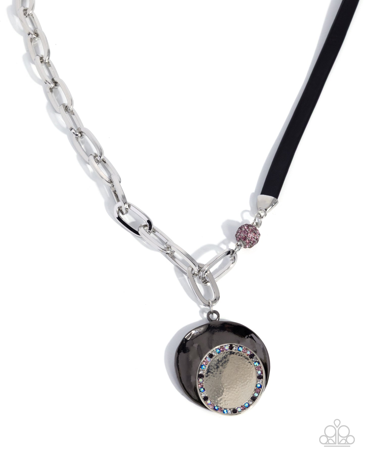 A silver-toned chain necklace with a black pendant featuring a textured gold center, a border of rhinestones, and a small pink rhinestone accent on a black cord, shown on a white background.