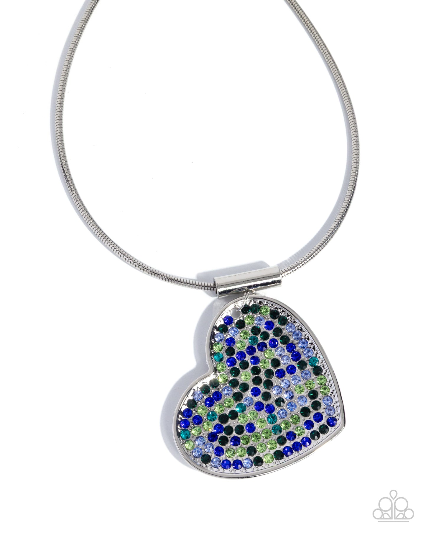 A heart-shaped pendant necklace with a silver-toned metal frame and a textured surface of blue, green, and black rhinestones, suspended from a silver snake chain on a white background.
