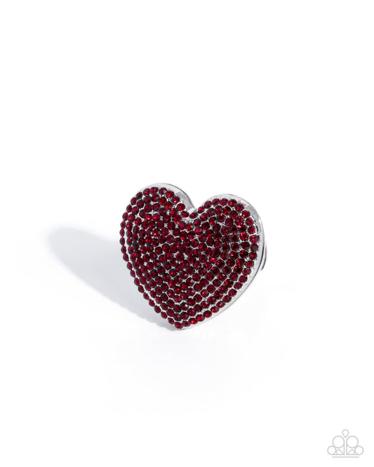 Heart-shaped brooch with red gemstones on a white background