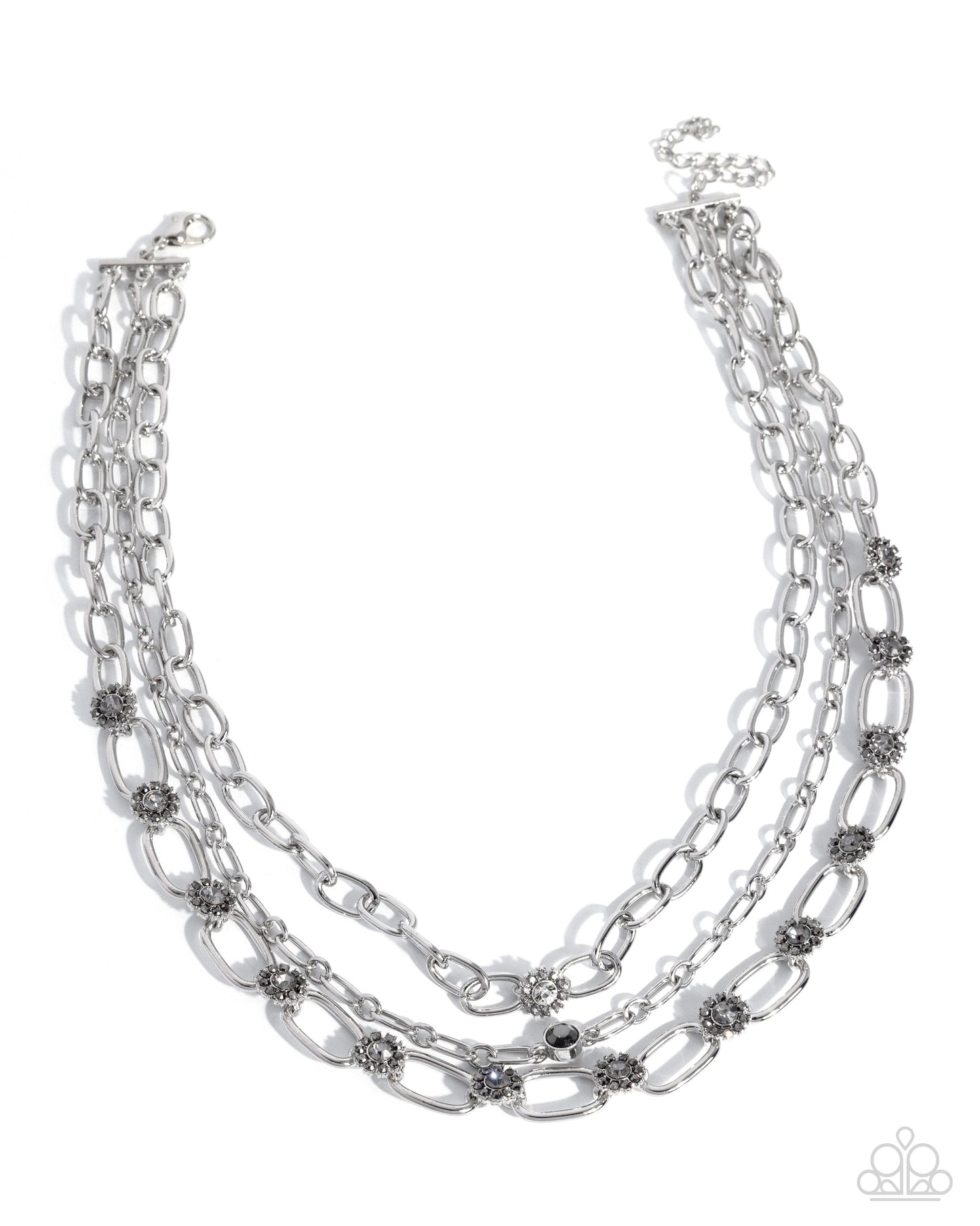 Multi-layered silver chain necklace with small embellishments on a white background
