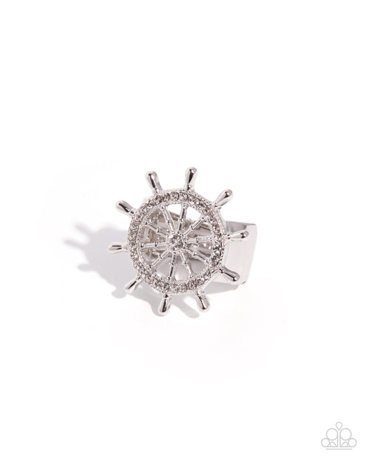 Silver ship's wheel with gemstones on a white background
