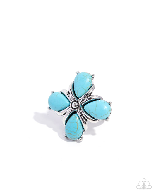Turquoise flower-shaped ring with silver band on white background