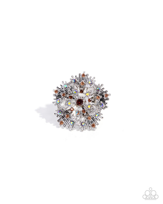 Decorative brooch with multicolored gemstones on a white background