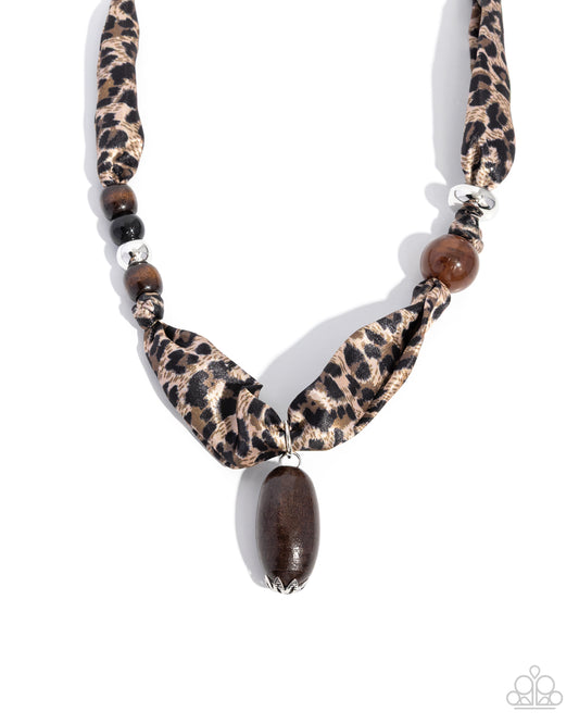 Leopard print necklace with wooden beads on a white background