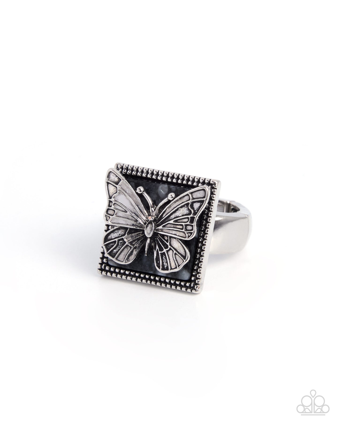 Silver butterfly ring with black square stone on a white background