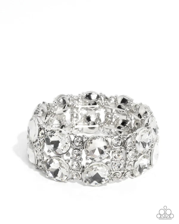 Silver ring with crystal-like stones on a white background