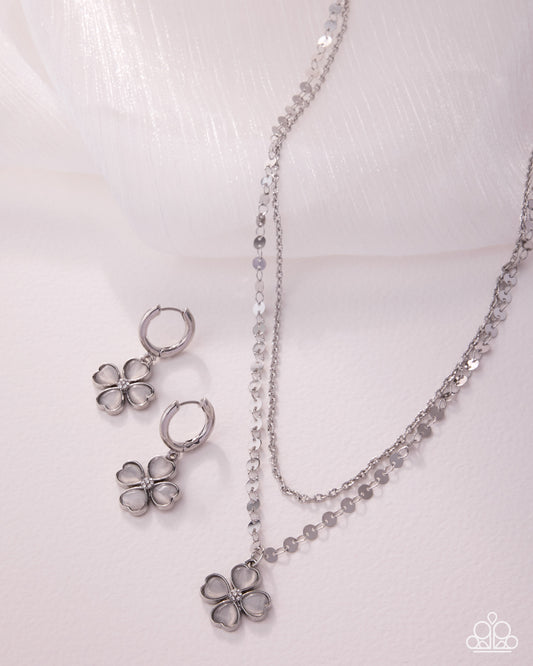 Silver flower jewelry set on a white background