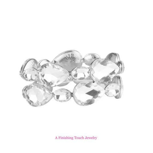 Silver bracelet with clear crystals on a white background, branded 'A Finishing Touch Jewelry'.