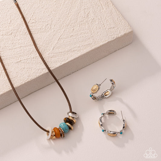 A jewelry set featuring a brown cord necklace with colorful spacer beads and matching silver hoop earrings with gold and turquoise accents, styled on a textured cream block and a light beige surface.