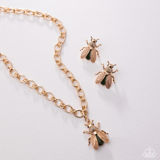 Gold bee-themed necklace and earrings on a light gray background