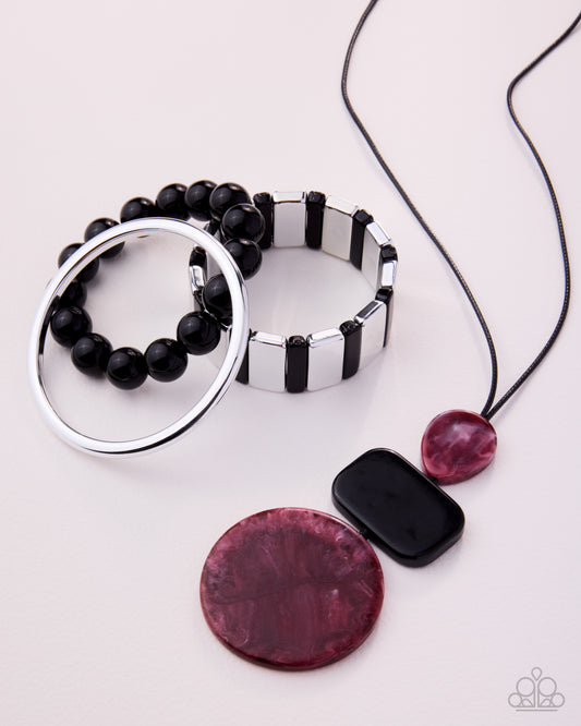 Jewelry set with black beaded bracelet, silver ring, pink and black pendant on a white background