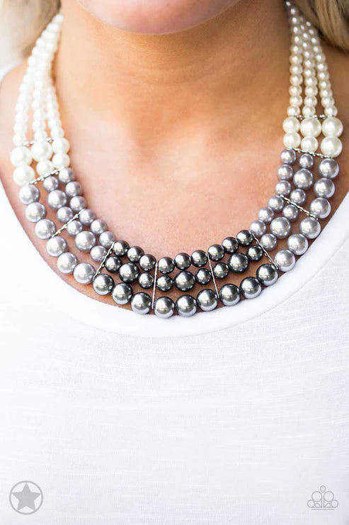 Necklace with white and silver beads on a plain background