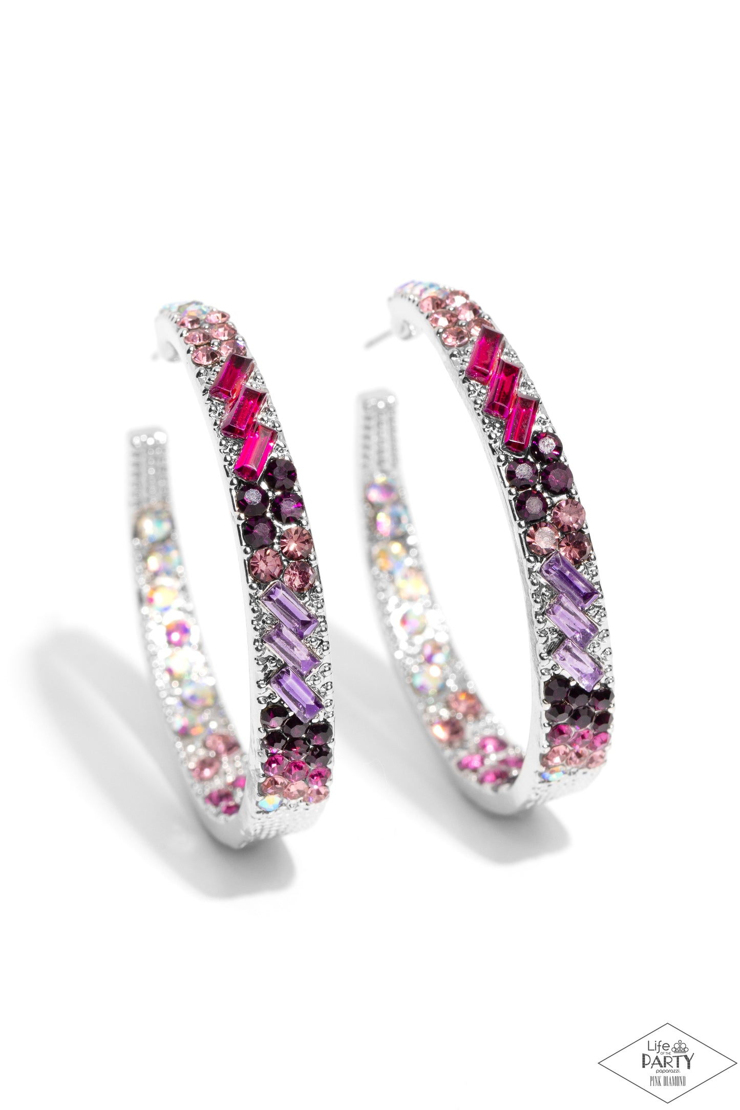 A pair of silver hoop earrings embellished with multiple rows of pink, purple, and iridescent clear crystals, shown on a white background with a small 'The Party' logo in the bottom right corner.