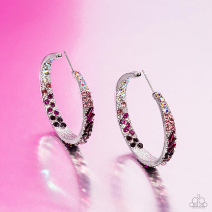 Silver hoop earrings with multicolored gemstones on a pink background