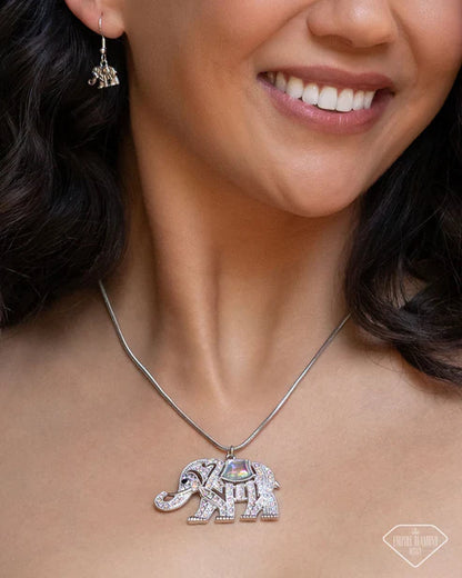 Close-up of a woman wearing a silver elephant pendant necklace.