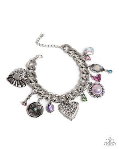 Silver chain bracelet with various charms on a white background