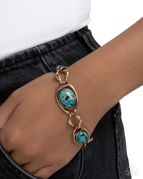 Bracelet with turquoise stones on a wrist against a white background